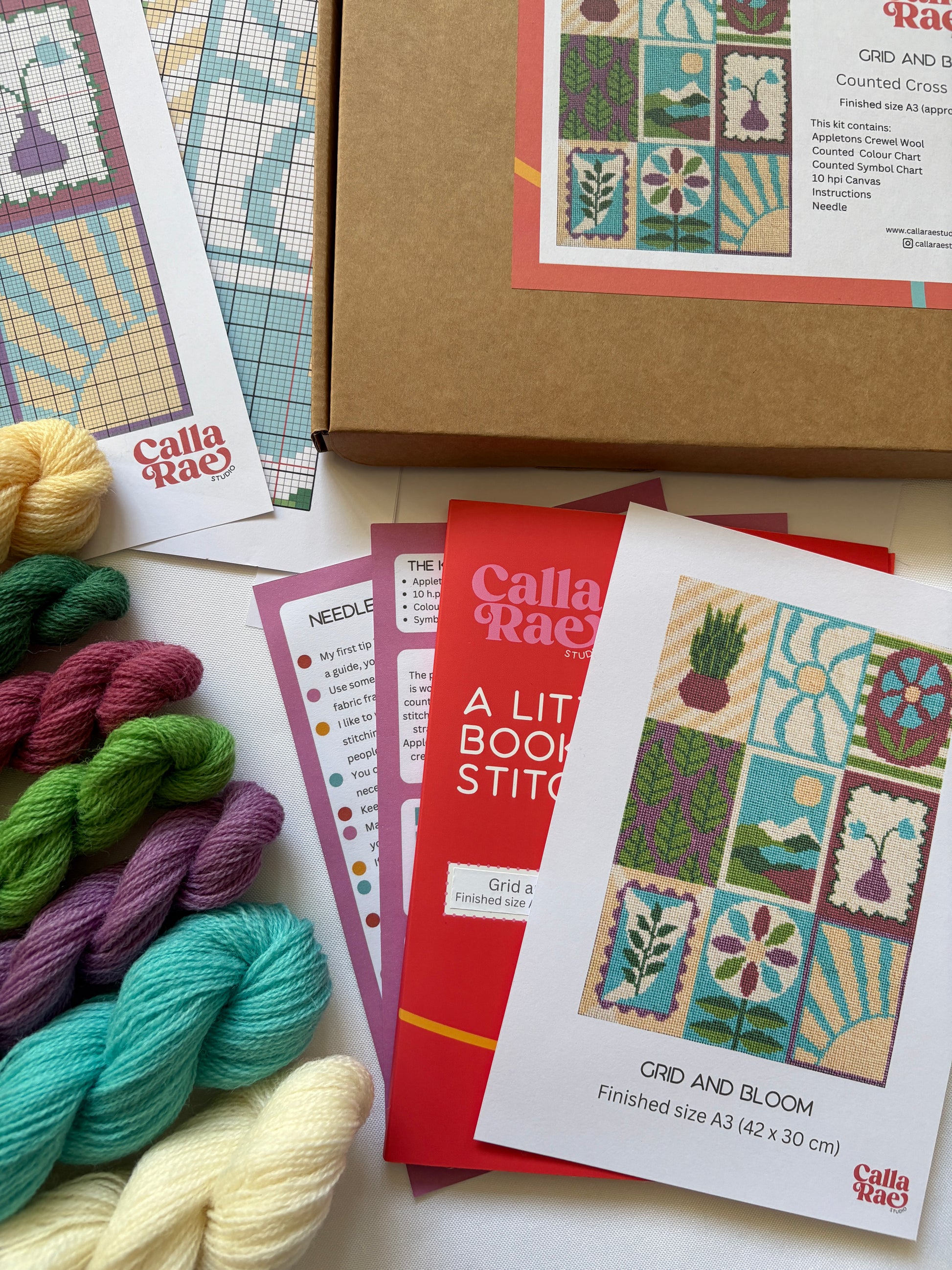 Grid and Bloom Cross stitch kit contents including Appleton wool hanks, pattern charts, instructions and packaging by Calla Rae Studio